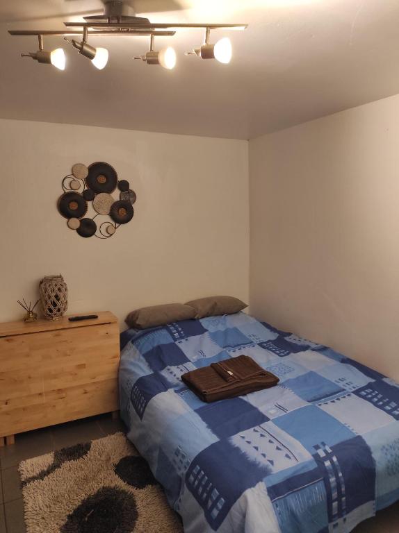 une chambre avec un lit et une commode en bois dans l'établissement happy petite venise, à Colmar
