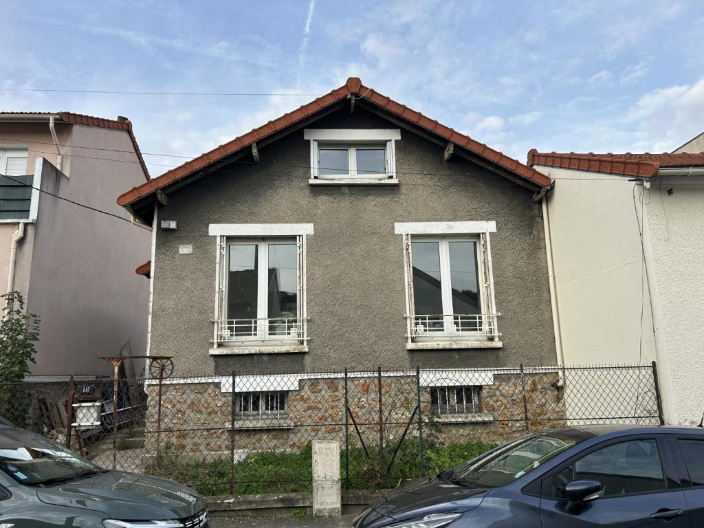 a brown house with two windows and a fence at Grand Paris Cozy Stay Private Studios and Apartment Quick Access to Paris in Vitry-sur-Seine