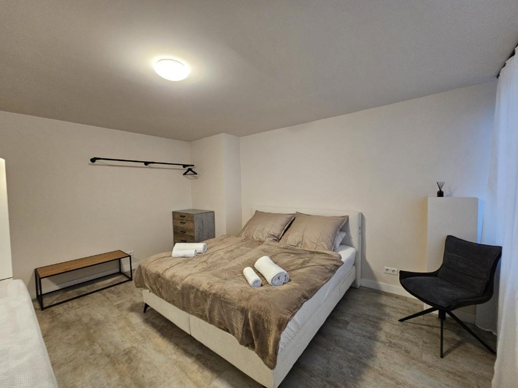 a bedroom with a bed and a chair in it at Modern townhouse in Wuppertal in Wuppertal
