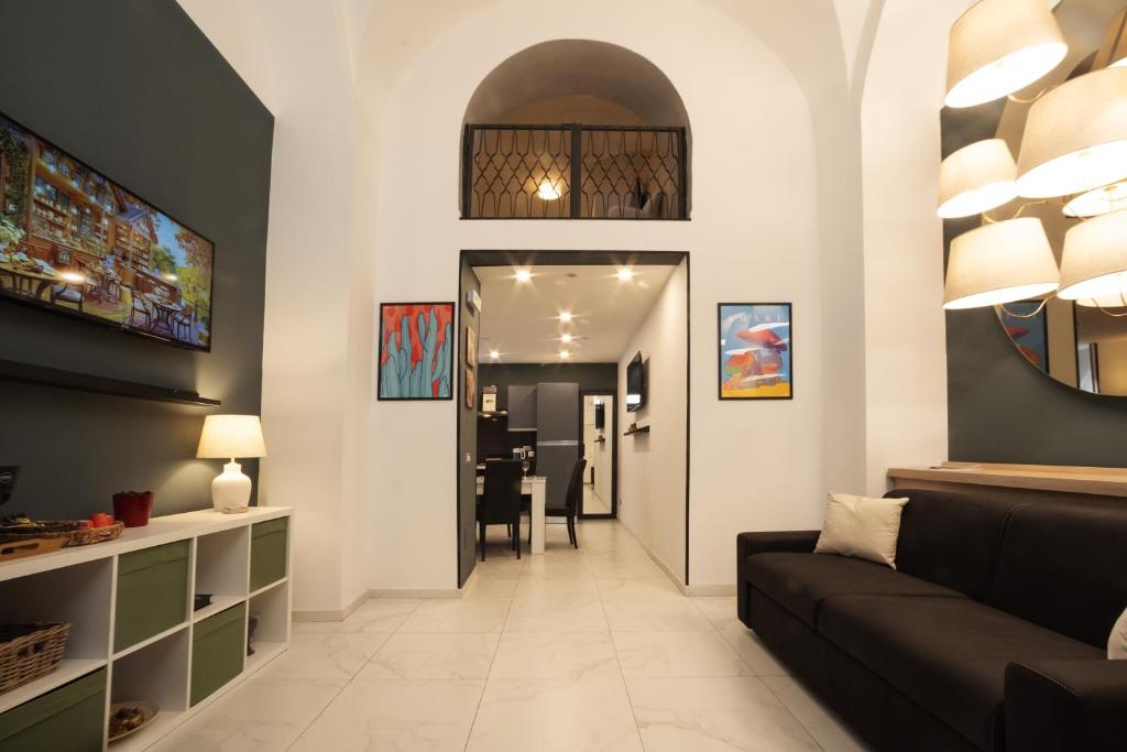 a living room with a couch and a table at Lume Guest House in Catania