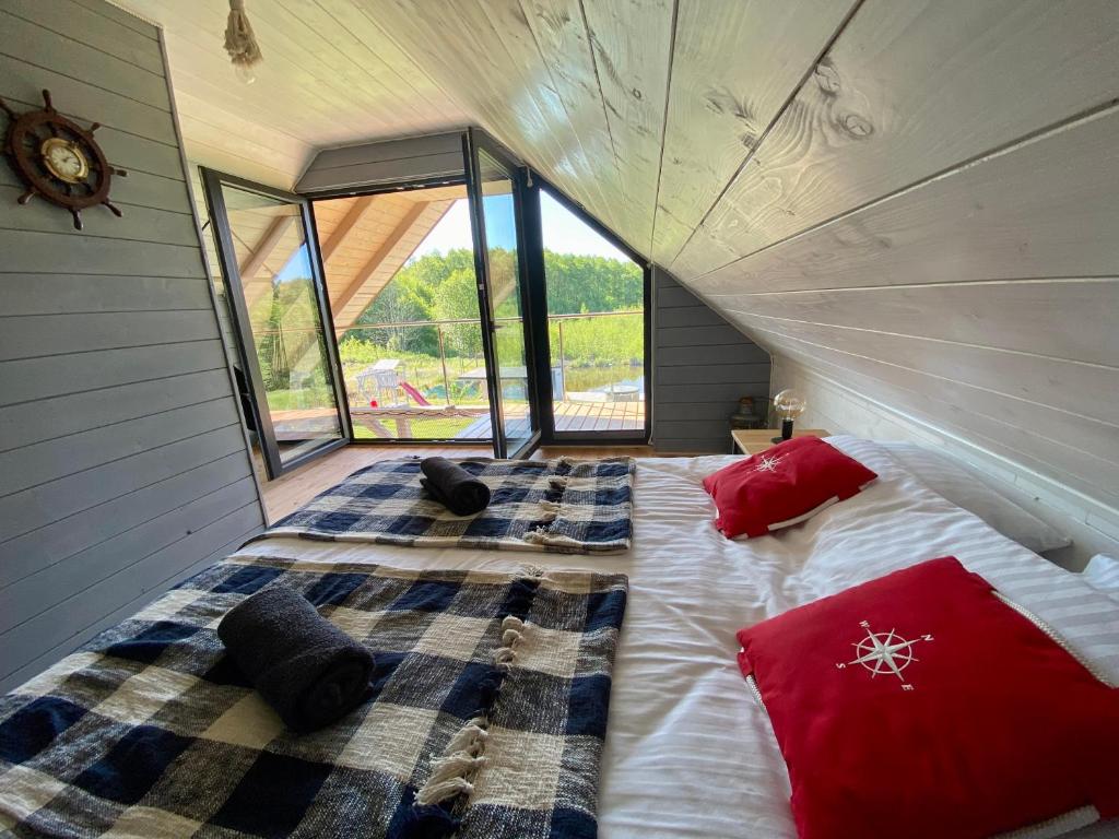 a bedroom with a large bed in a house at Mazurski Domek - Wake Up Home Ogonki in Ogonki