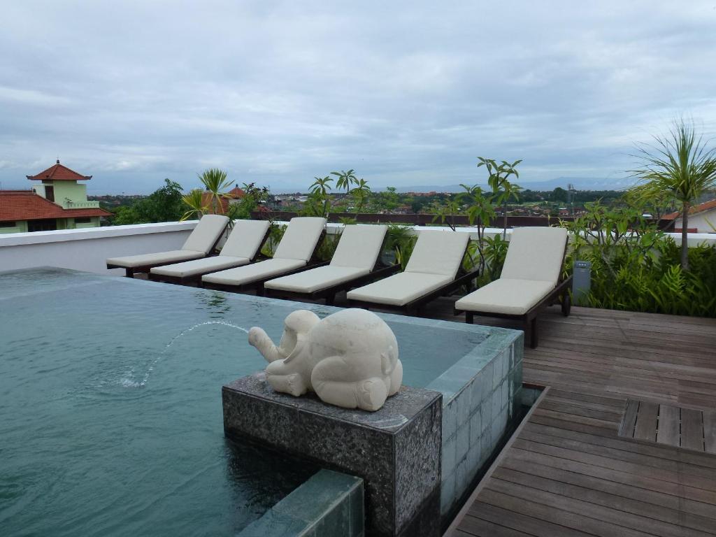 a statue of an elephant sitting on top of a pool at Allia Residence in Nusa Dua
