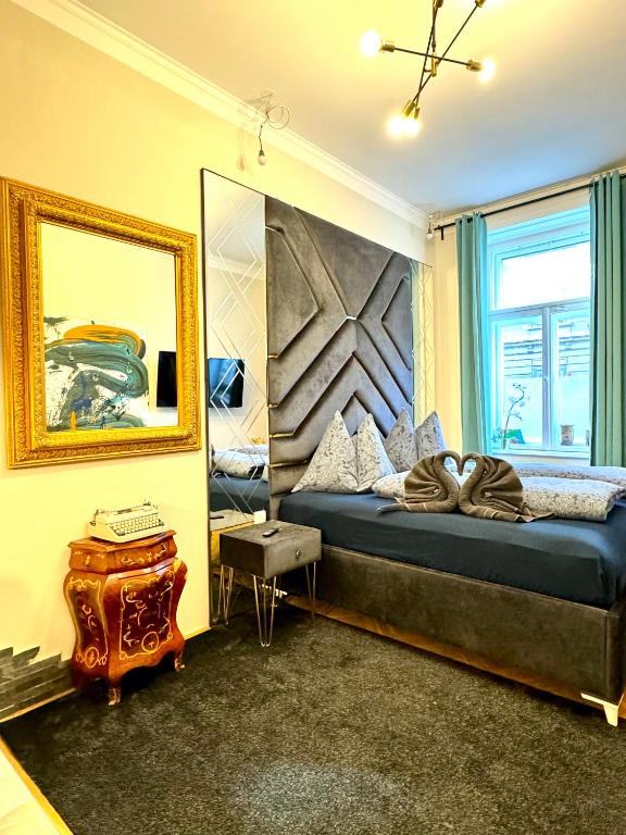 a bedroom with a bed and a mirror at Belvedere Apartment in Vienna
