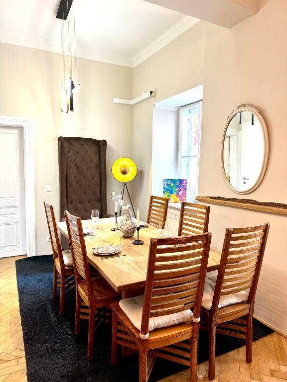 a dining room with a wooden table and chairs at Belvedere Apartment in Vienna