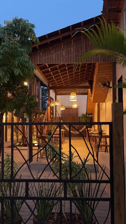 a patio with tables and chairs in a building at Pousada Ocazum Ilha do Amor in Alter do Chao