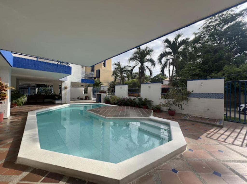 a swimming pool in front of a house at Apartamento soberana del mar bello horizonte in Playa Bello Horizonte