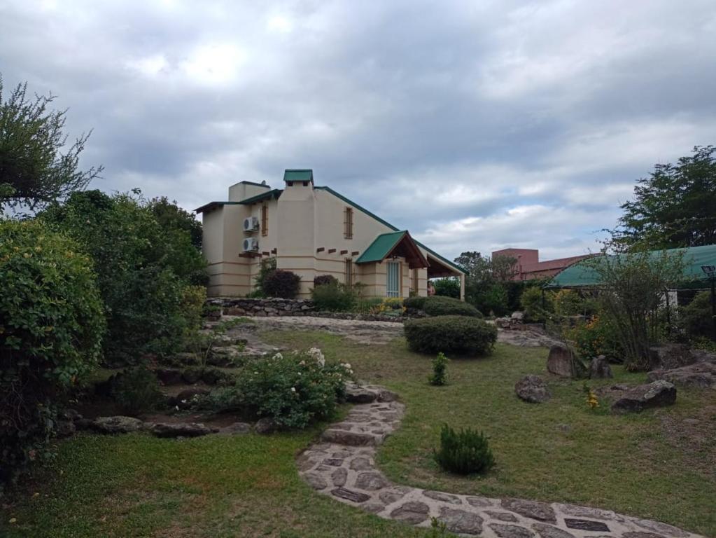 a house with a garden in front of it at Champ Cervi in San Antonio de Arredondo