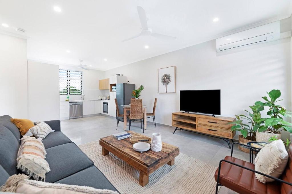 a living room with a couch and a tv at 'Tres Botanica' Nightcliff Escape for Groups, Three Adjacent Apartments in Nightcliff