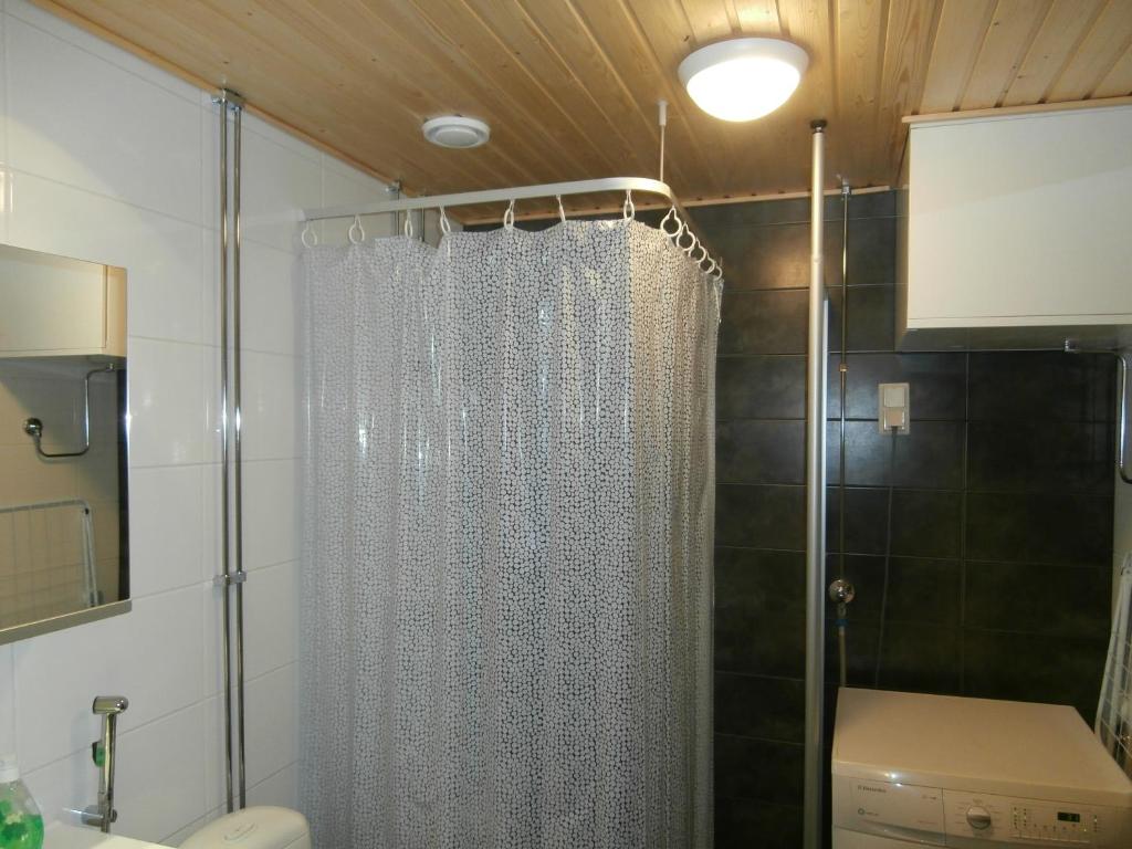 a shower curtain in a bathroom with a toilet at Apartment Nallisuites in Oulu