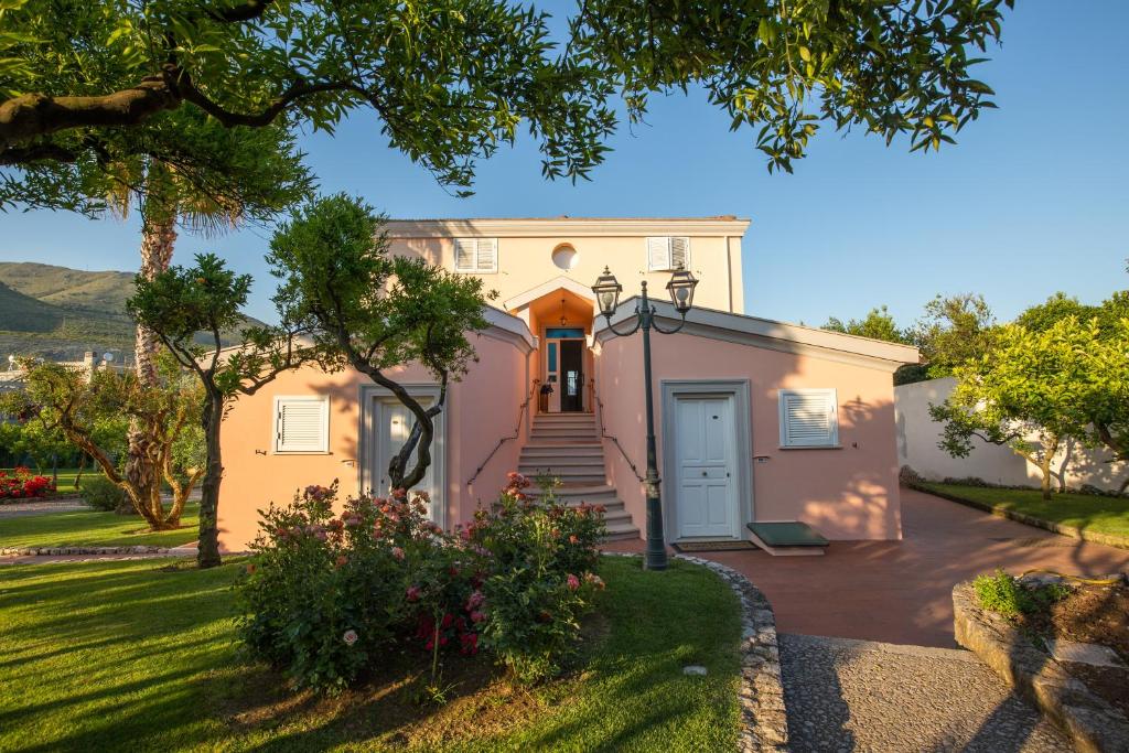 a white house with a door and a yard at Villa Irlanda Grand Hotel in Gaeta