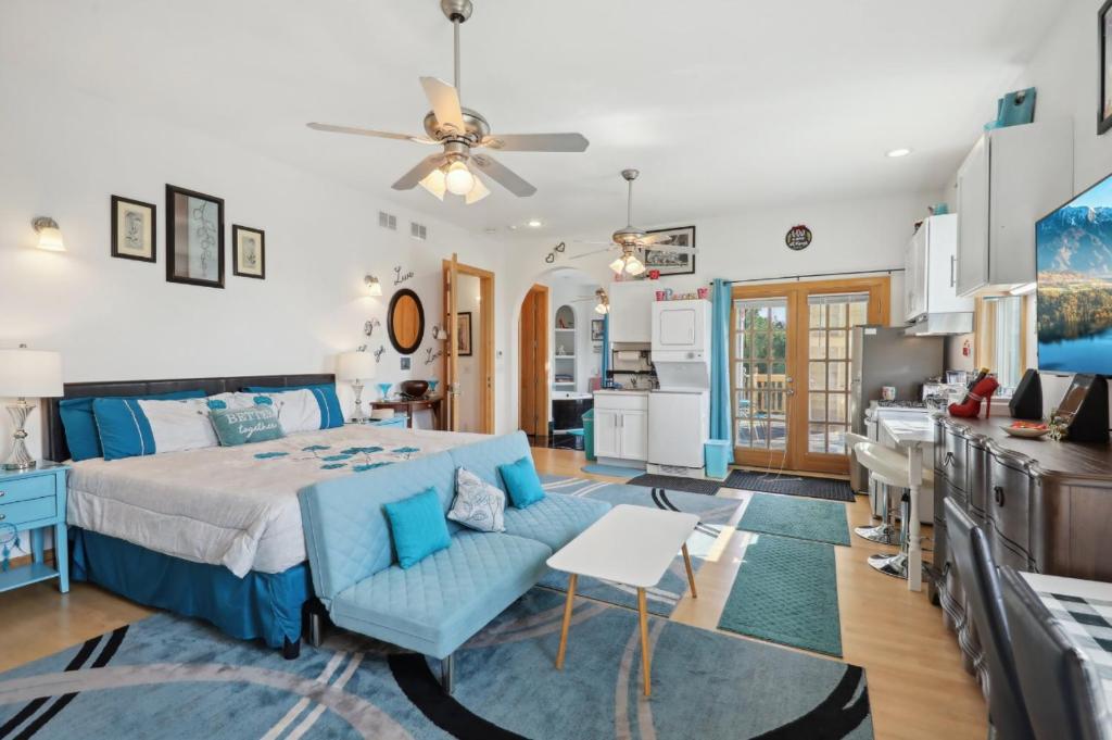 een slaapkamer met een bed en een blauwe bank bij The Starlight Tower Hot Tub Suite with 8-Jet Massage Shower and Amazing Views in Fort Atkinson