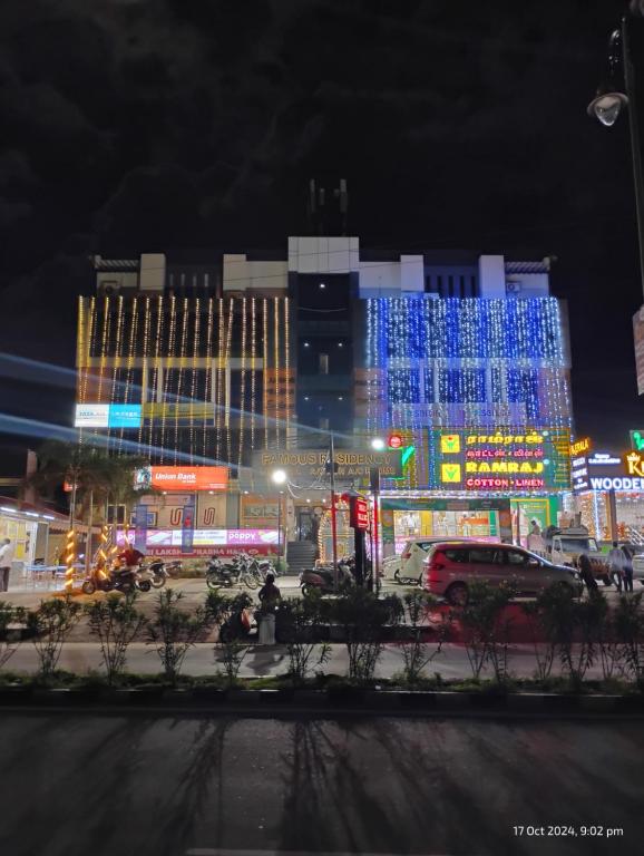 a city at night with blue lights on buildings at Famous Residency in Tiruchirappalli