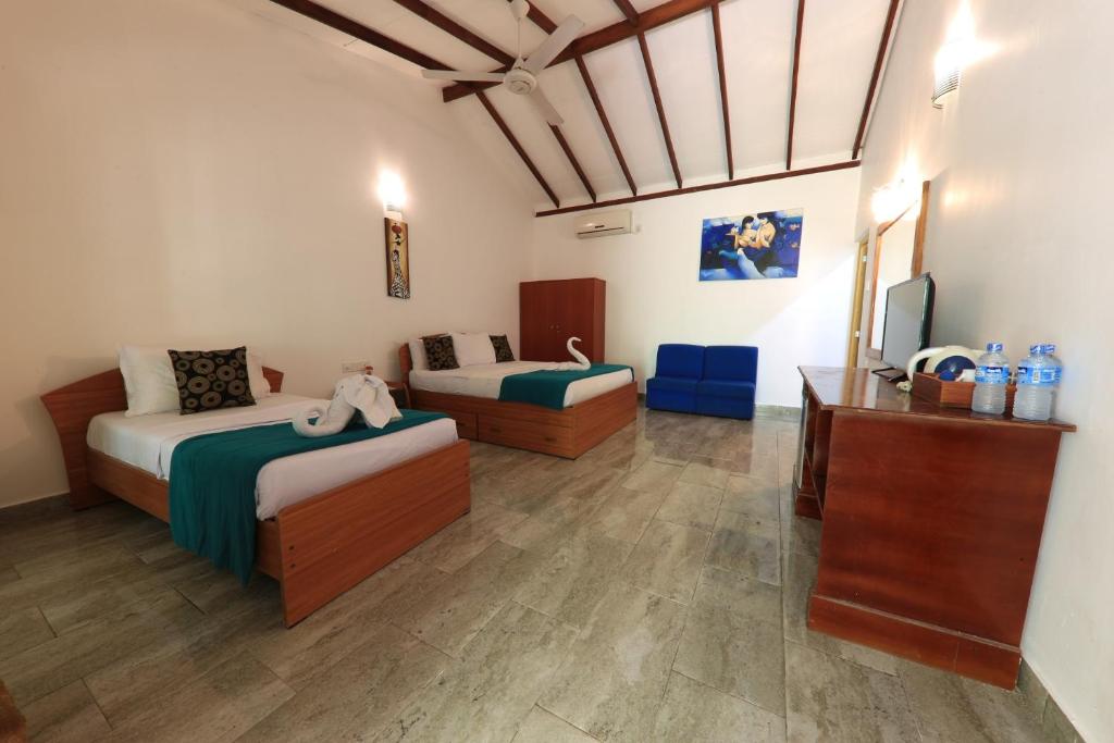 Postel nebo postele na pokoji v ubytování Sundaras Resort LTD