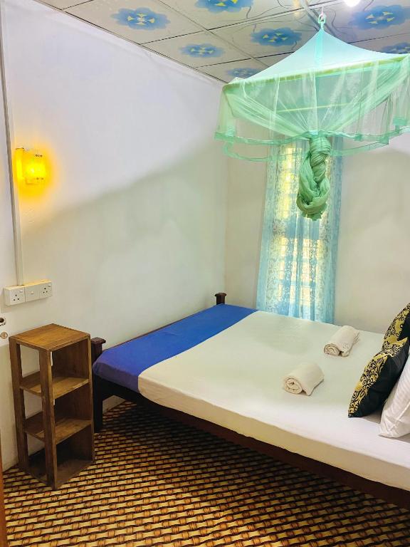 Postel nebo postele na pokoji v ubytování Sigiri Lakshan Home Stay