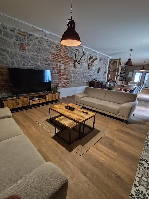 a living room with a couch and a coffee table at Villa MILIA in Bátovce