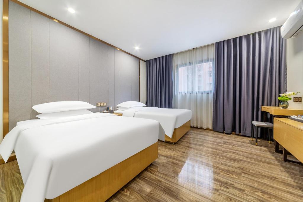 Postel nebo postele na pokoji v ubytování 泊汀酒店广州北京路步行街省中医店