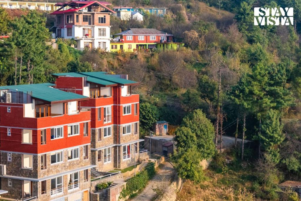 an aerial view of houses on a hill at StayVista at Grove - Elysium Estate with Hill View, Lawn in Shimla
