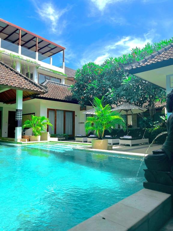 a swimming pool in front of a building at Villa Casablanca Surf Keramas in Keramas