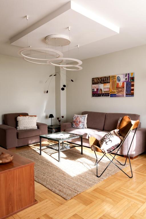 a living room with a couch and a table at Delux apartment Moj Osijek, SELF CHECK-IN in Osijek