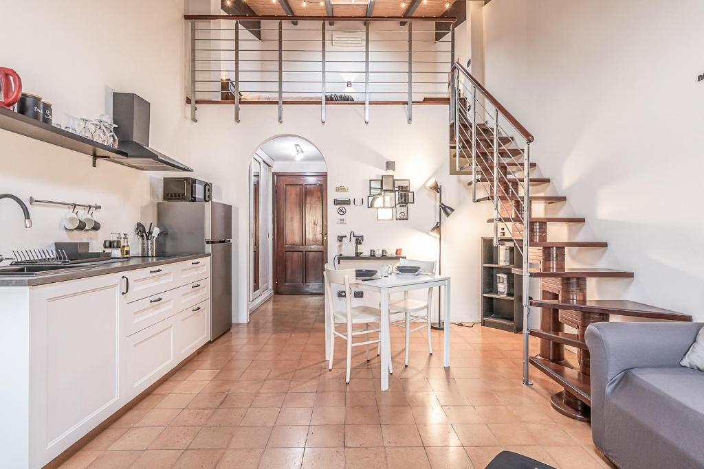 a kitchen with a staircase and a table in a room at [Chardonnay]- elegante appartamento in Cavezzo