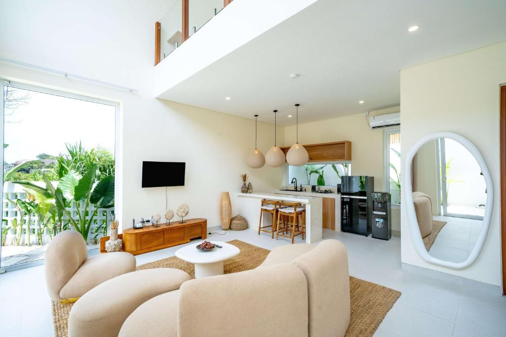 a living room with a couch and a table at Lyma Loft Pererenan in Canggu