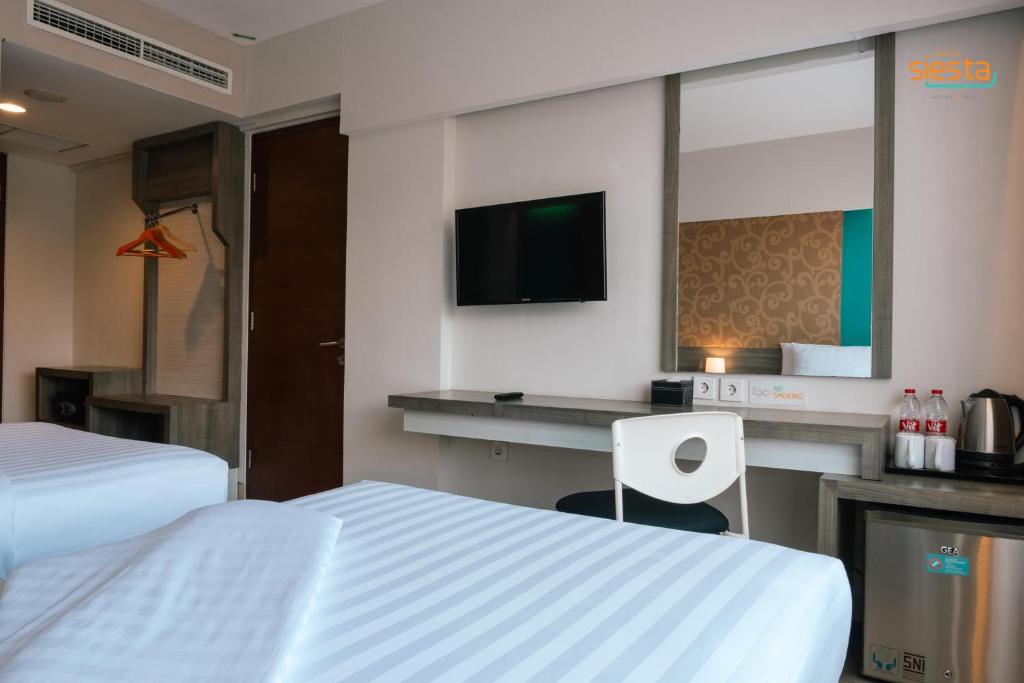 Postel nebo postele na pokoji v ubytování Siesta Legian