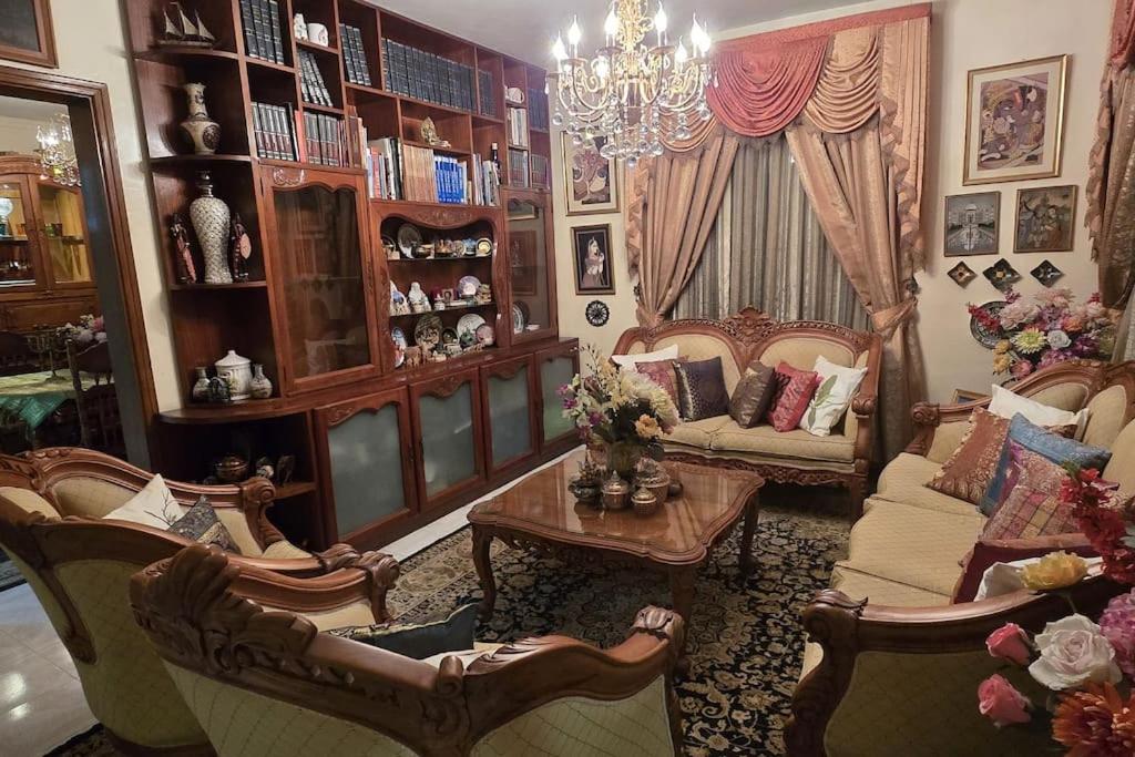 a living room with chairs and a couch and a table at Mauritian Home in the country in Lalmatie