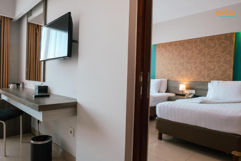 Postel nebo postele na pokoji v ubytování Siesta Legian