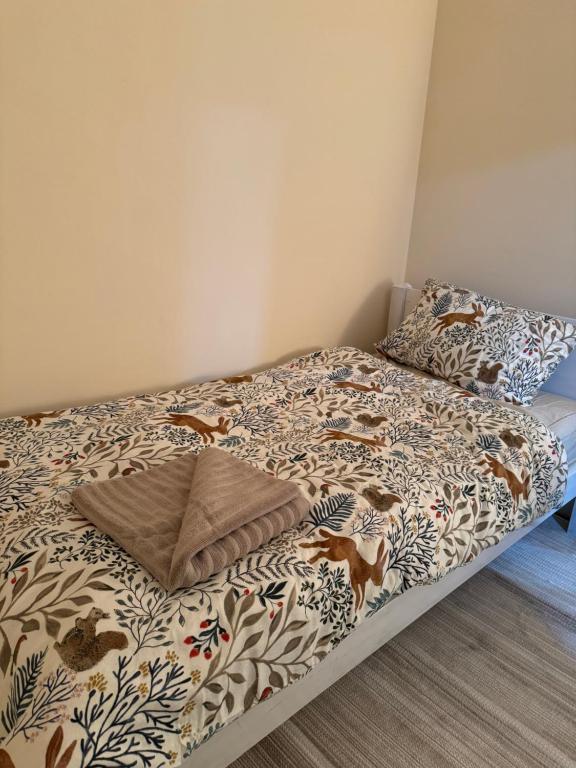 a bed in a bedroom with a comforter and pillows at Snow hill rooms in Birmingham