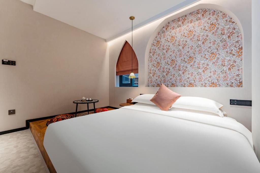 Postel nebo postele na pokoji v ubytování Chaozhou Fanhuali B&B