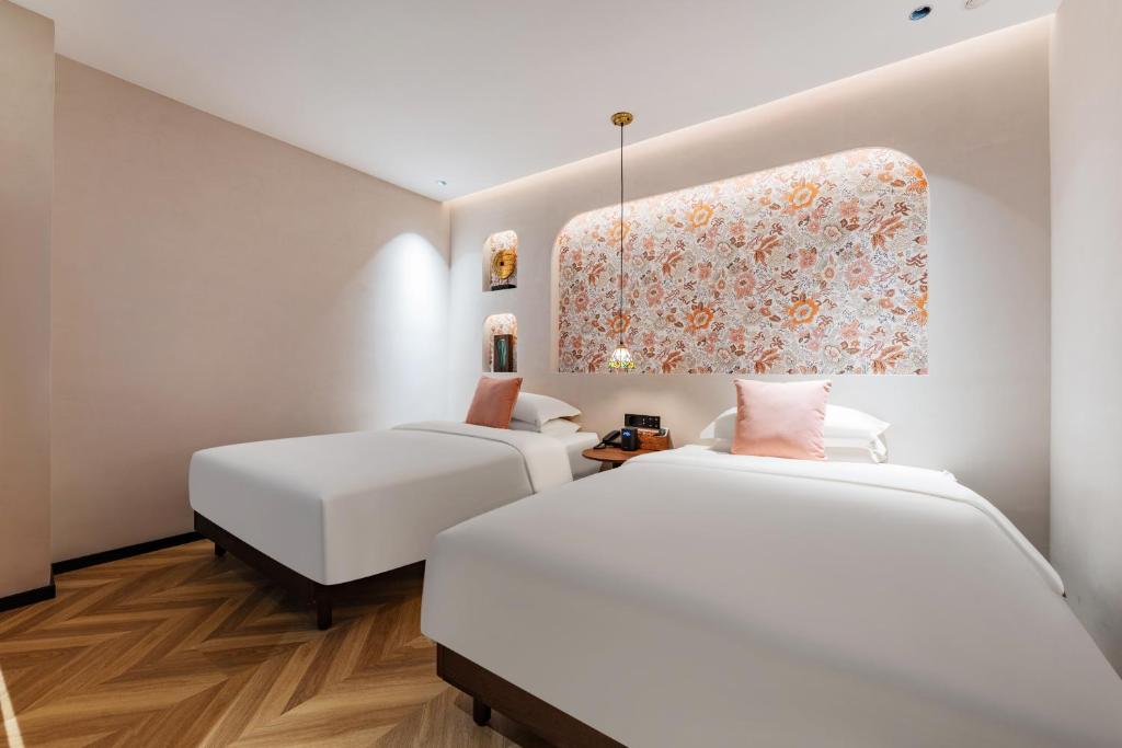 Postel nebo postele na pokoji v ubytování Chaozhou Fanhuali B&B