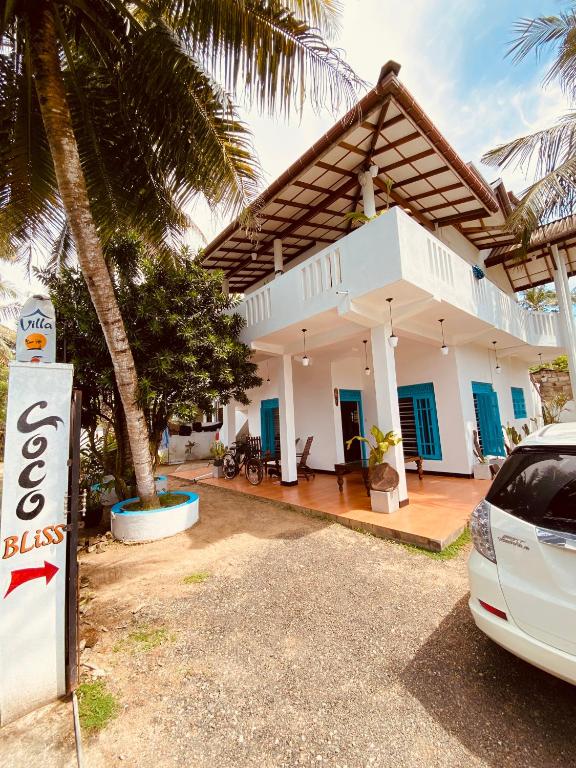 a house with a car parked in front of it at Coco Bliss - Ahangama in Ahangama
