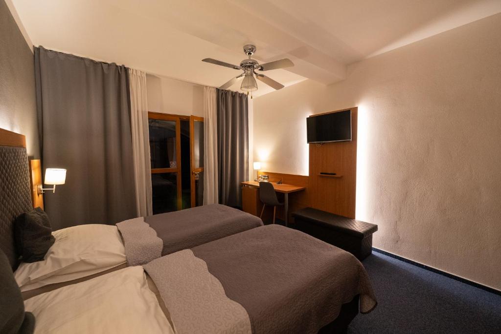 Postel nebo postele na pokoji v ubytování Hotel Rustikal Hustopeče - U Mandloňových sadů