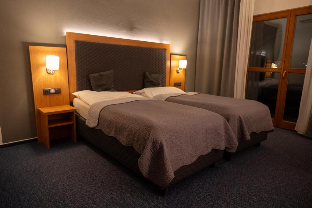 Postel nebo postele na pokoji v ubytování Hotel Rustikal Hustopeče - U Mandloňových sadů