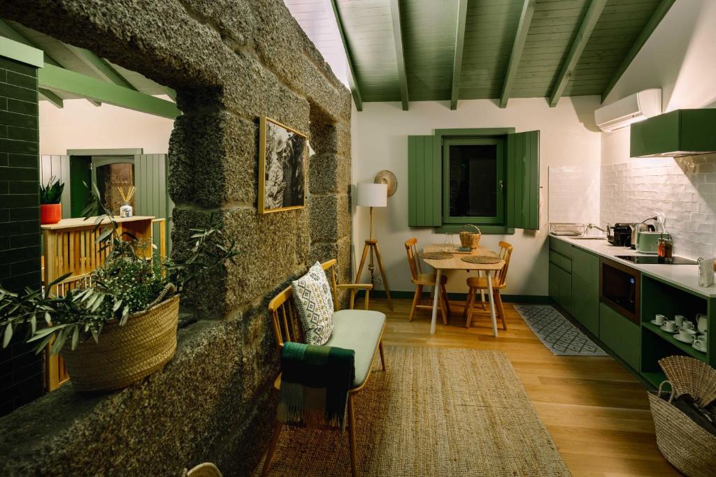 a kitchen with green cabinets and a table at Vila Coura in Amarante