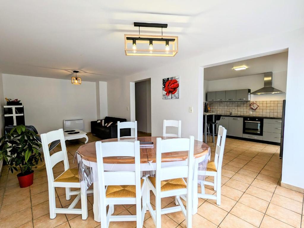 a kitchen and dining room with a table and chairs at Gîte rénové avec parking à proximité de Saint-Dié-des-Vosges - FR-1-589-675 in Saint-Michel-sur-Meurthe