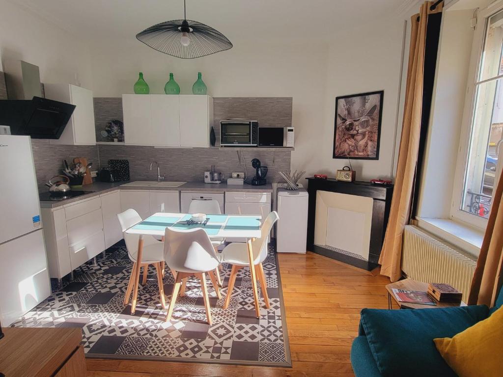 une cuisine avec une table et des chaises dans une pièce dans l'établissement Appartement 3 étoiles avec terrasse privée à Nancy - FR-1-584-344, à Nancy