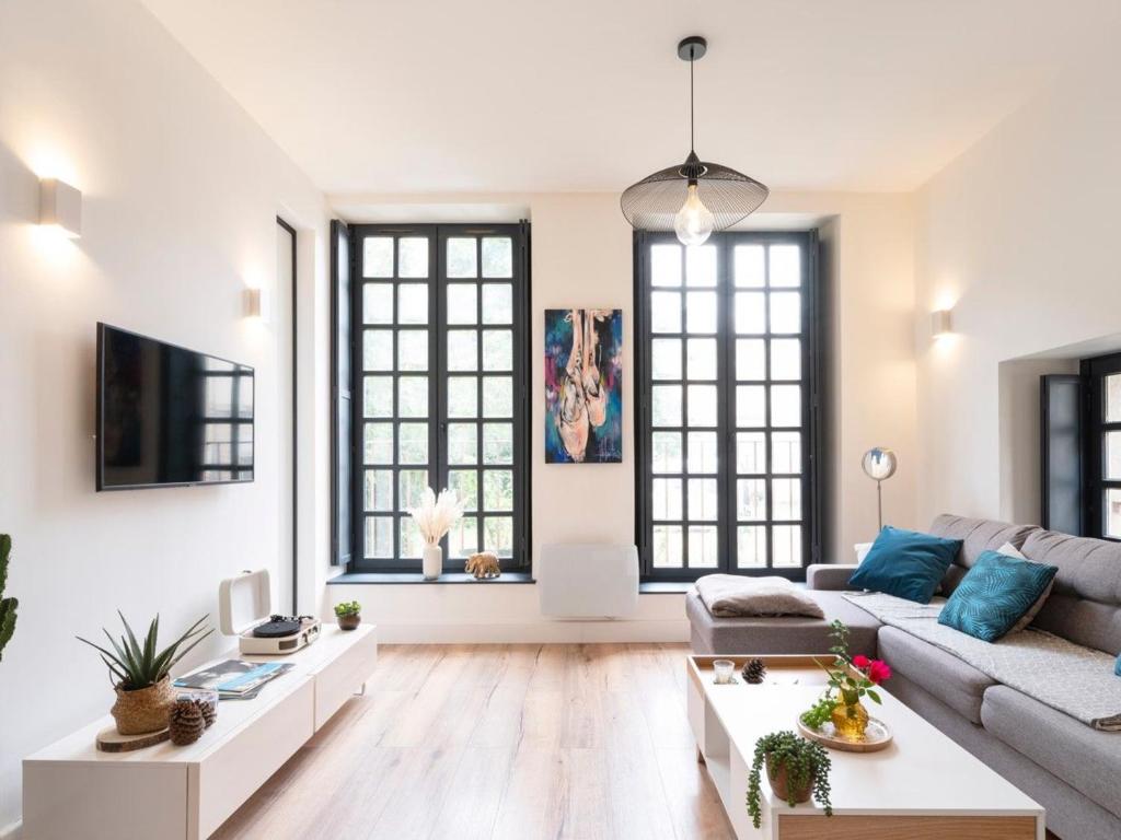 a living room with a couch and a table at Appartement moderne proche Place Stanislas - FR-1-584-349 in Nancy