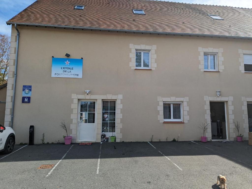 a building with a parking lot in front of it at Maison spacieuse et contemporaine avec parking, vélos et baby-foot en Berry - FR-1-591-649 in Neuvy-Saint-Sépulchre