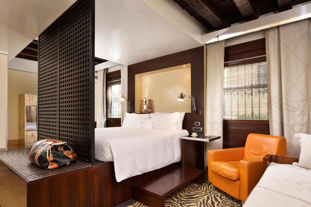 a hotel room with a bed and a chair at Ca' Pisani Hotel in Venice