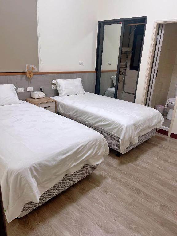 Postel nebo postele na pokoji v ubytování Xianwang Homestay