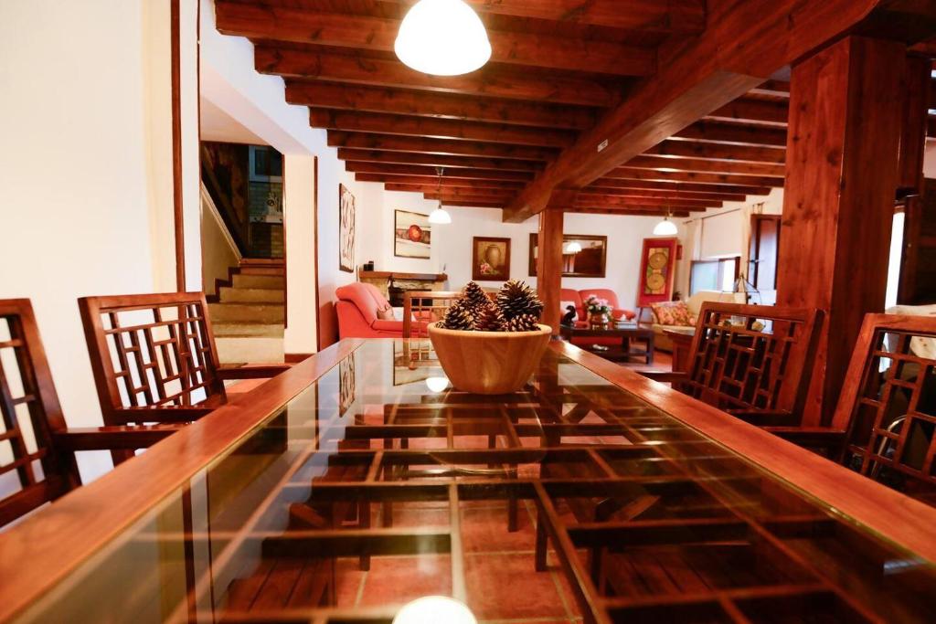 a dining room with a large glass table with a bowl on it at Rural Enjoy Cantabria in Arnuero