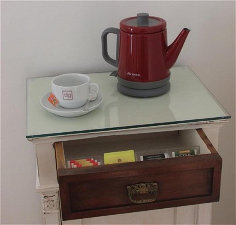 a table with a tea pot and a cup on it at Palazzo De Giorgi B&B in Lecce