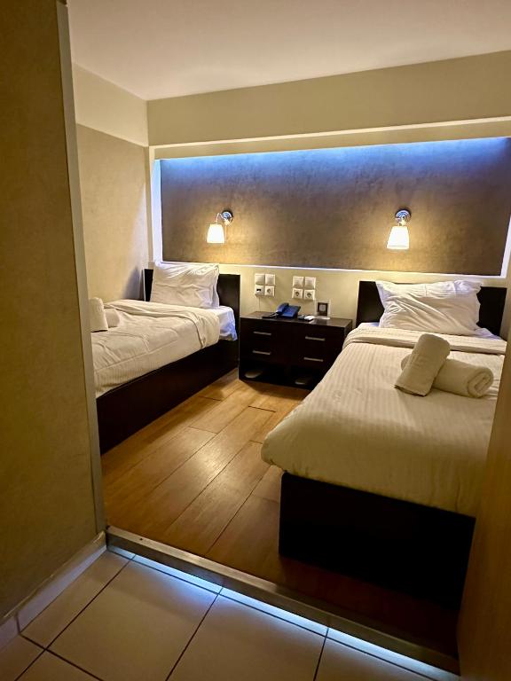 Postel nebo postele na pokoji v ubytování Mc Queen Rooms & Apartments