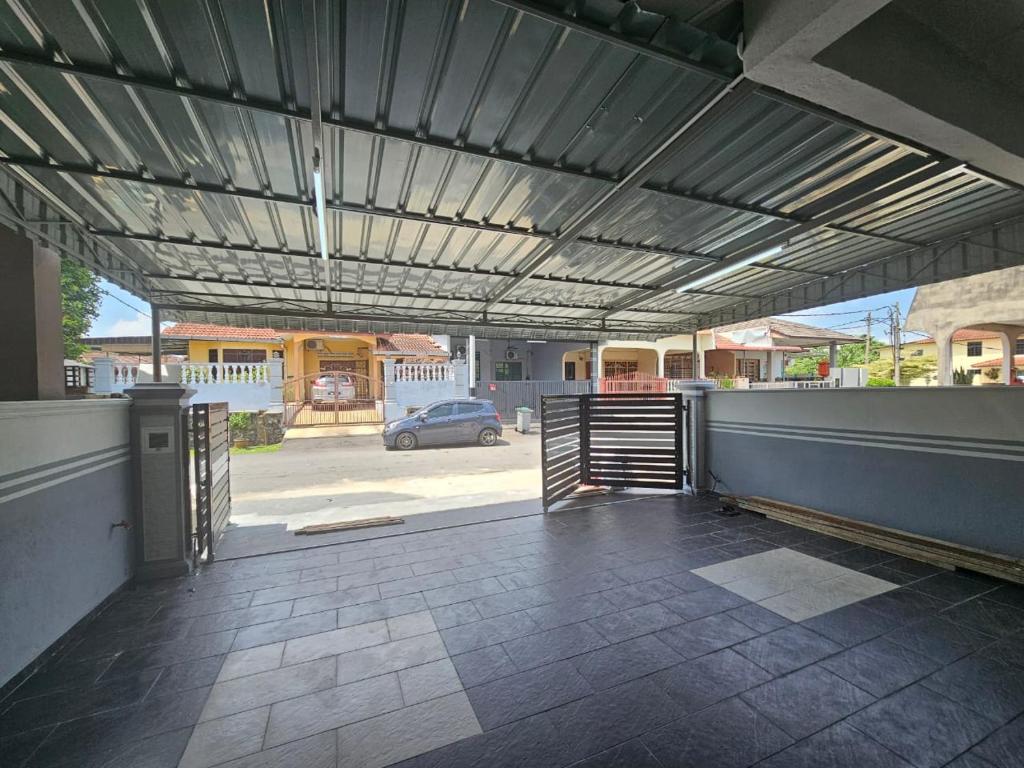 an open garage with awning on a house at Ayaani Homestay in Kuala Pilah