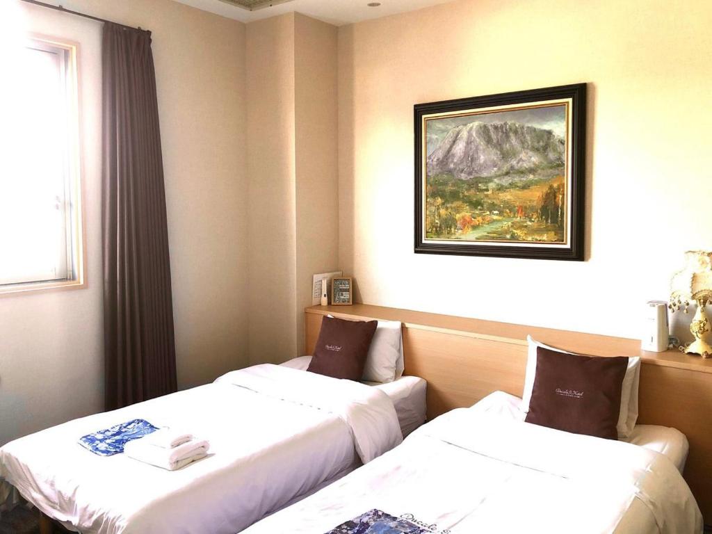 Postel nebo postele na pokoji v ubytování Ducale Garden Hotel Kujukuri