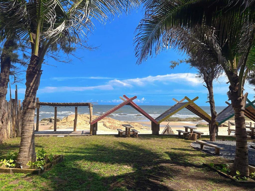 a park with benches and trees on the beach at Waikiki Lagi Beach homestay & restaurant in La Gi