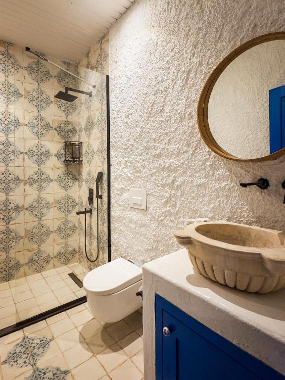 a bathroom with a toilet and a sink and a shower at Churchill Townhouse in Bodrum City