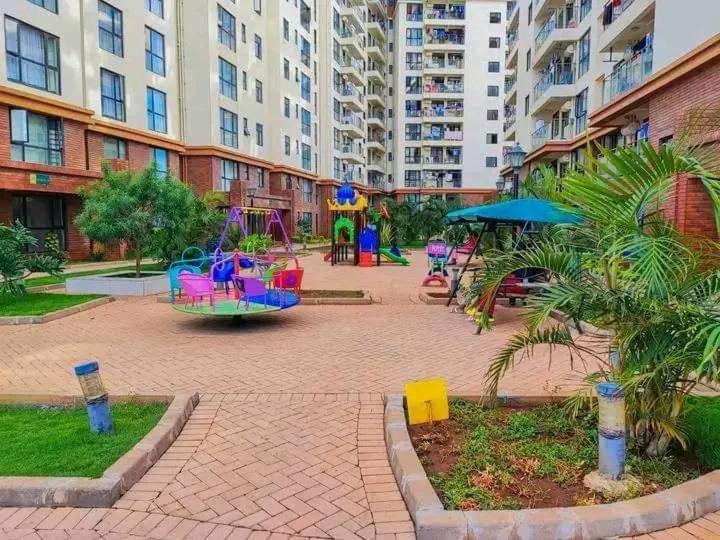 a park with a playground in a city at Apple Tree Apartment , 2 bedroom Luxury suites in Syokimau
