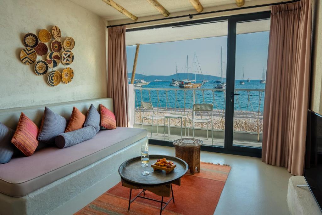 a living room with a couch and a view of the water at Churchill Townhouse in Bodrum City